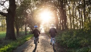 “Two kids riding bicycles during morning sunrise—starting the day with positivity and energy” 