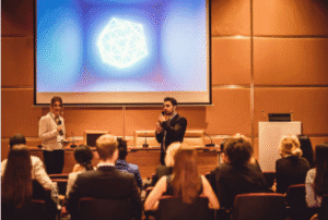 Confident young speaker on stage – How to Gain Confidence to Speak in Public
